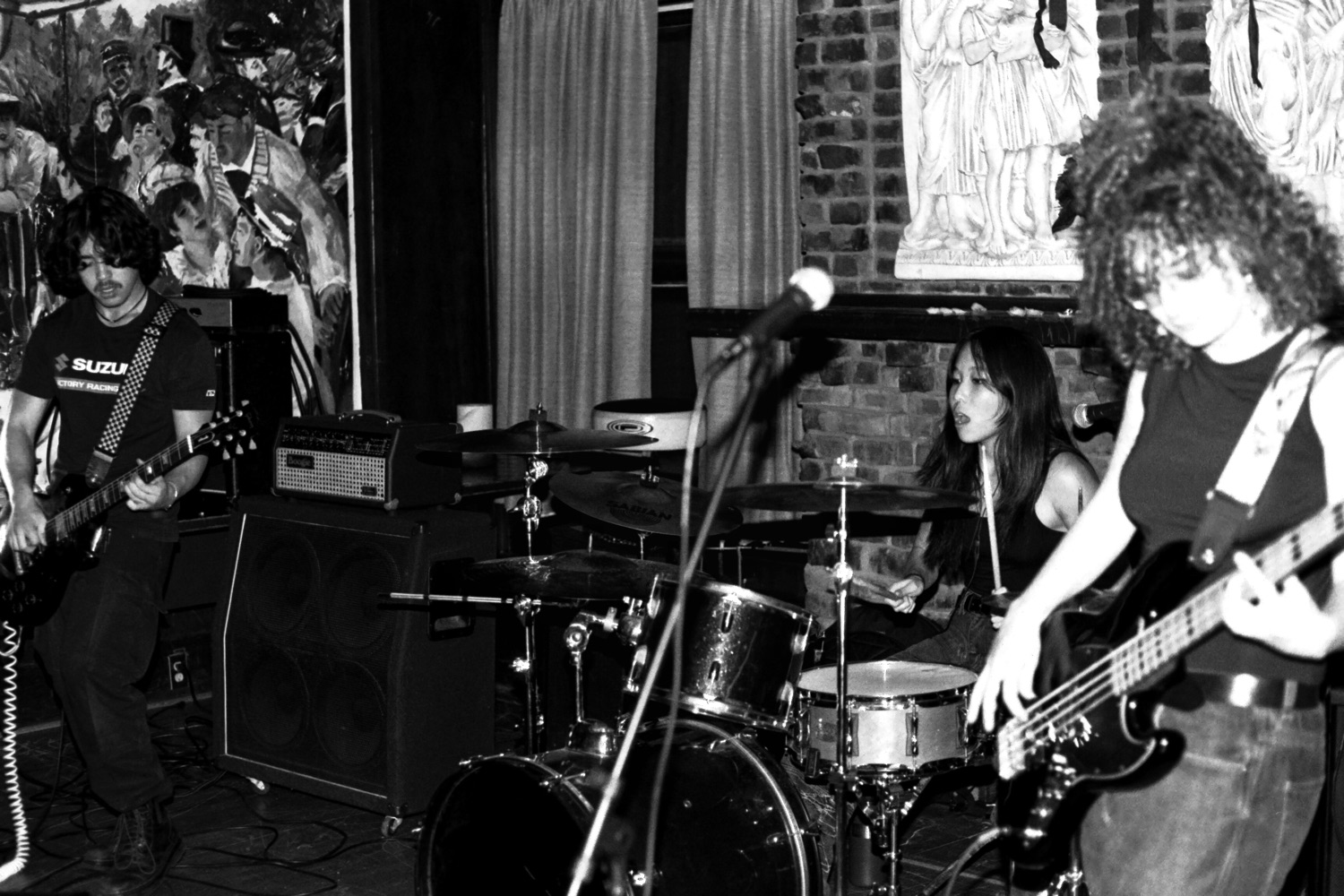 Hot Pocket Nepo Baby playing live, Tyan Lee on drums between two guitarists